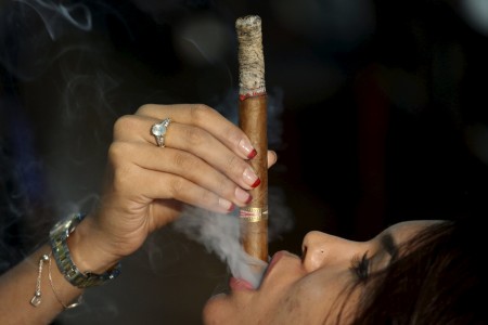 Francis Sierra smokes as she competes for the longest ash during the XVIII Habanos Festival in Havana